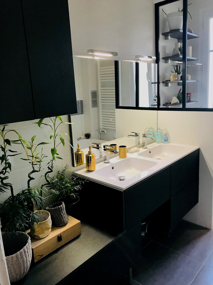 Photo of a mid-sized modern master bathroom in Paris with beaded inset cabinets, black cabinets, a drop-in tub, a two-piece toilet, black tile, mosaic tile, porcelain floors, a console sink, solid surface benchtops, black floor and white benchtops.