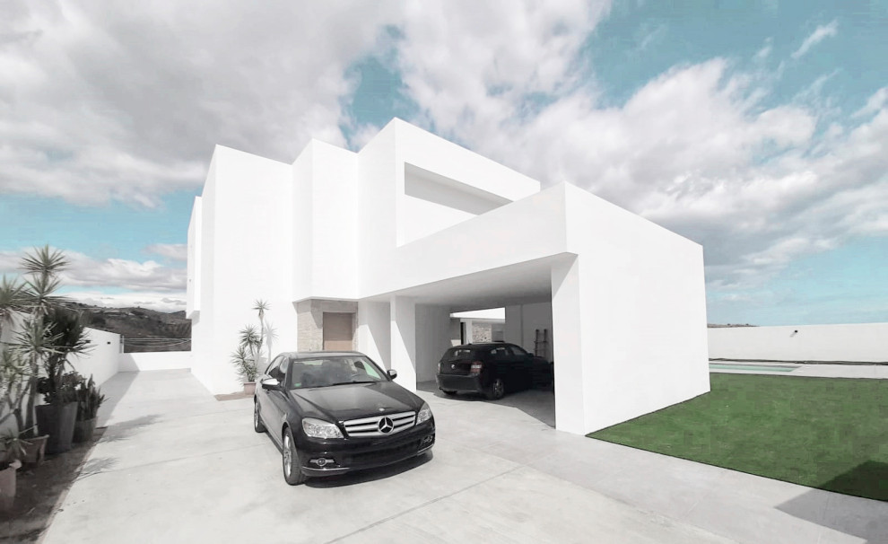 Inspiration for a large modern attached double carport in Malaga.