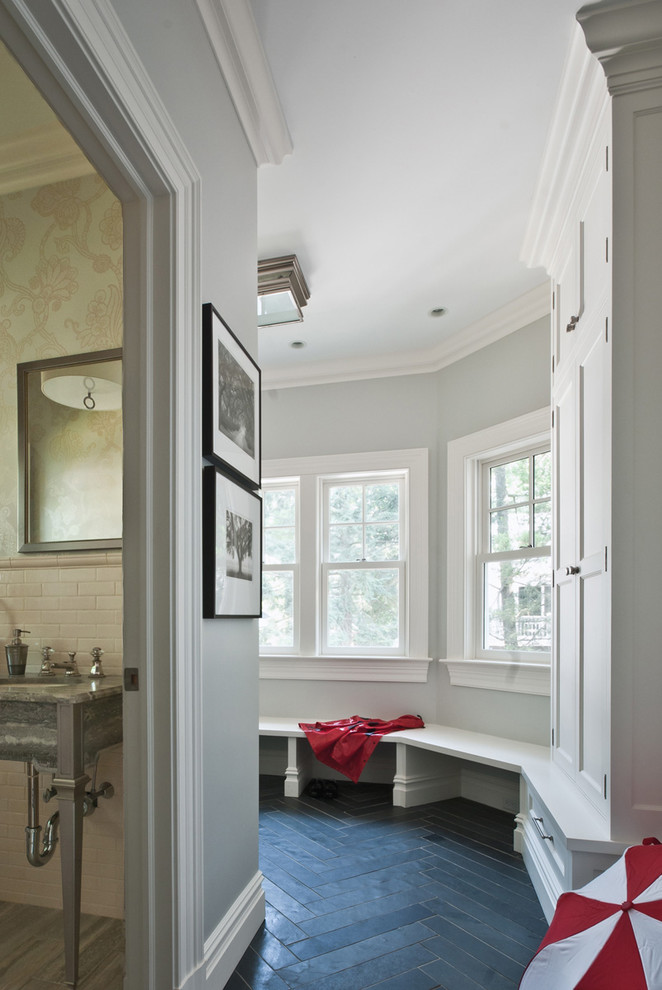 Inspiration for a traditional mudroom in New York with grey walls, slate floors and black floor.