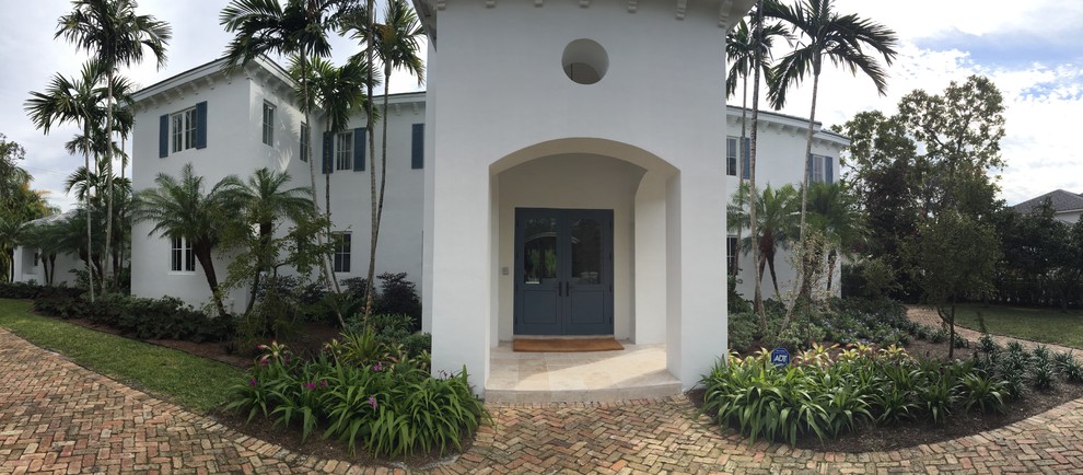 This is an example of a mid-sized transitional front door in Miami with white walls, porcelain floors, a double front door and a blue front door.