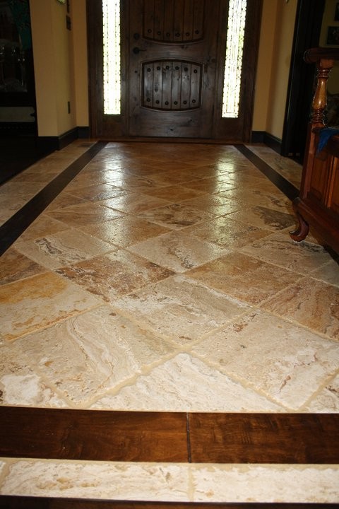 Inspiration for a mid-sized traditional entry hall in Atlanta with beige walls, travertine floors, a single front door, a dark wood front door and beige floor.