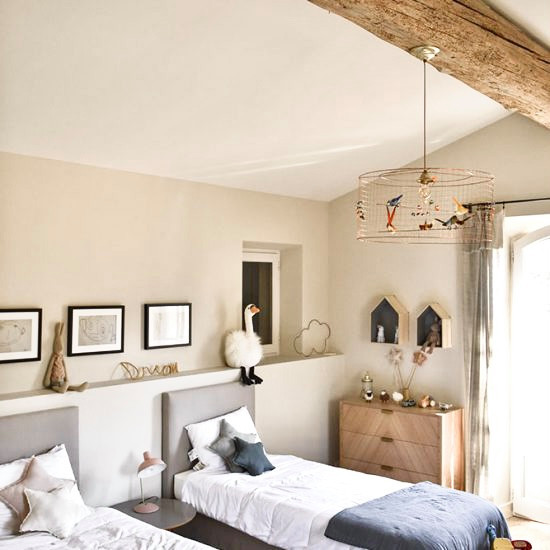 Design ideas for a medium sized farmhouse gender neutral kids' bedroom in Montpellier with beige walls, travertine flooring, beige floors and exposed beams.