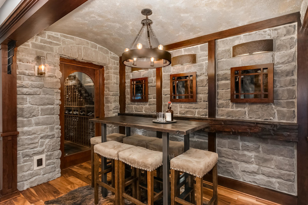 Design ideas for a large traditional wine cellar in Minneapolis with medium hardwood floors and brown floor.
