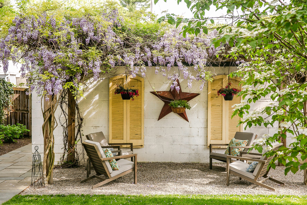 Shabby-chic style patio in DC Metro with gravel and a pergola.