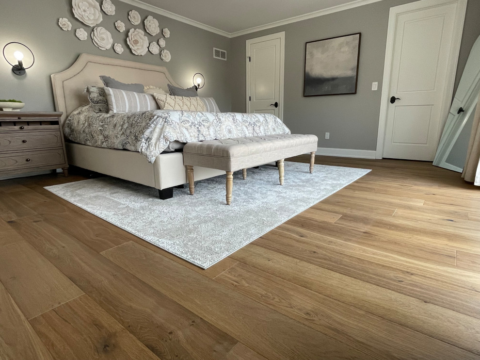 Design ideas for a large modern master bedroom in Other with grey walls, medium hardwood floors, no fireplace, a concrete fireplace surround, multi-coloured floor, vaulted and panelled walls.