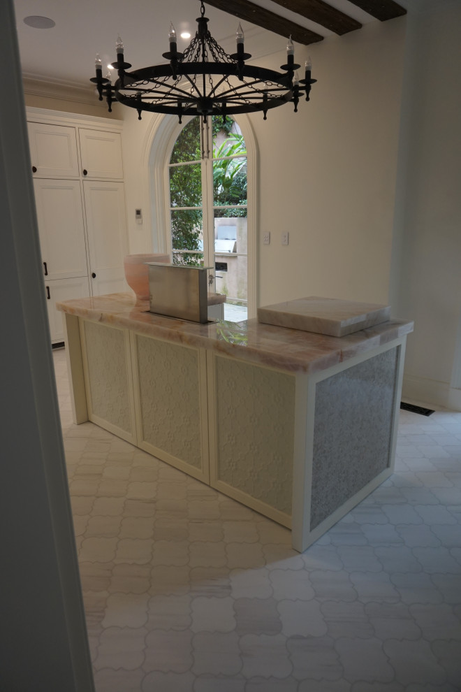 Inspiration for a mediterranean kitchen in Sydney with shaker cabinets, white cabinets, marble benchtops, white appliances, porcelain floors, with island, multi-coloured floor and pink benchtop.
