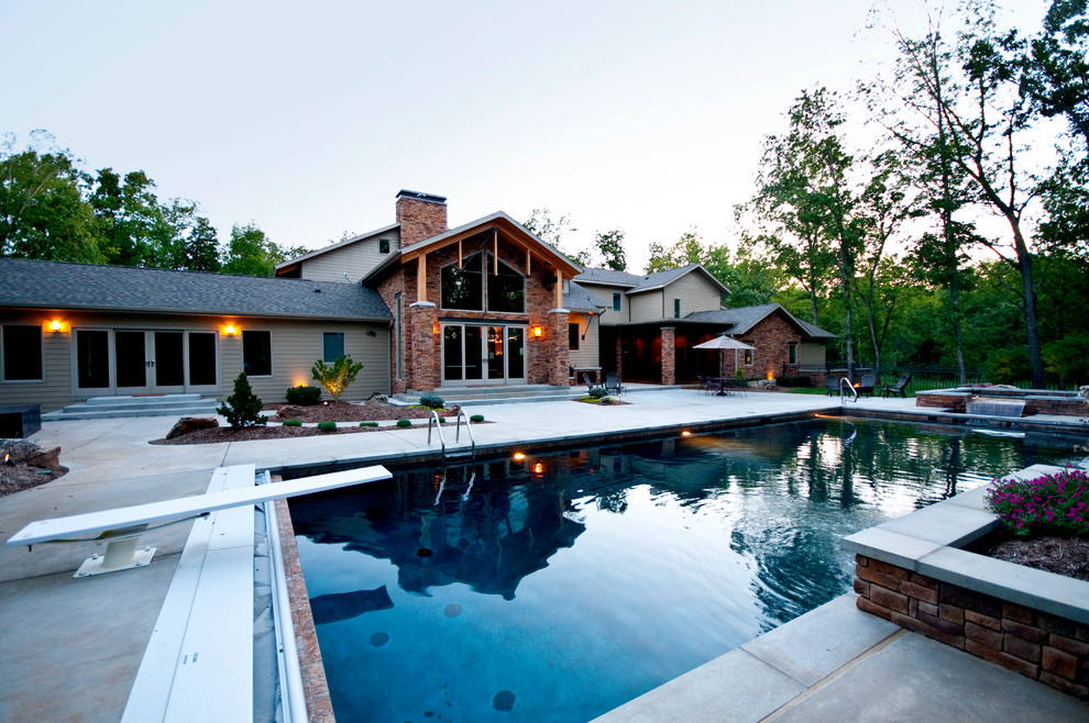 Design ideas for an expansive industrial backyard rectangular pool in Other with a water feature and concrete slab.