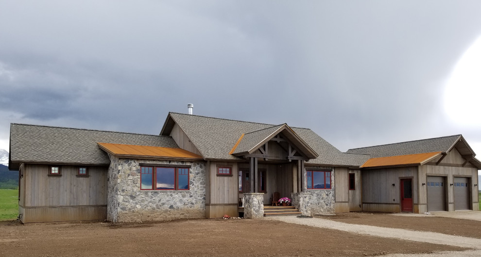 Inspiration for a large rustic brown two-story mixed siding and board and batten gable roof remodel with a shingle roof and a gray roof
