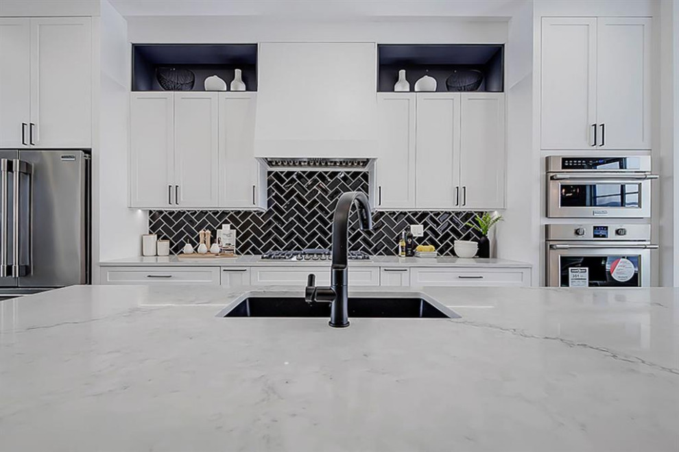Example of a transitional home design design in Calgary