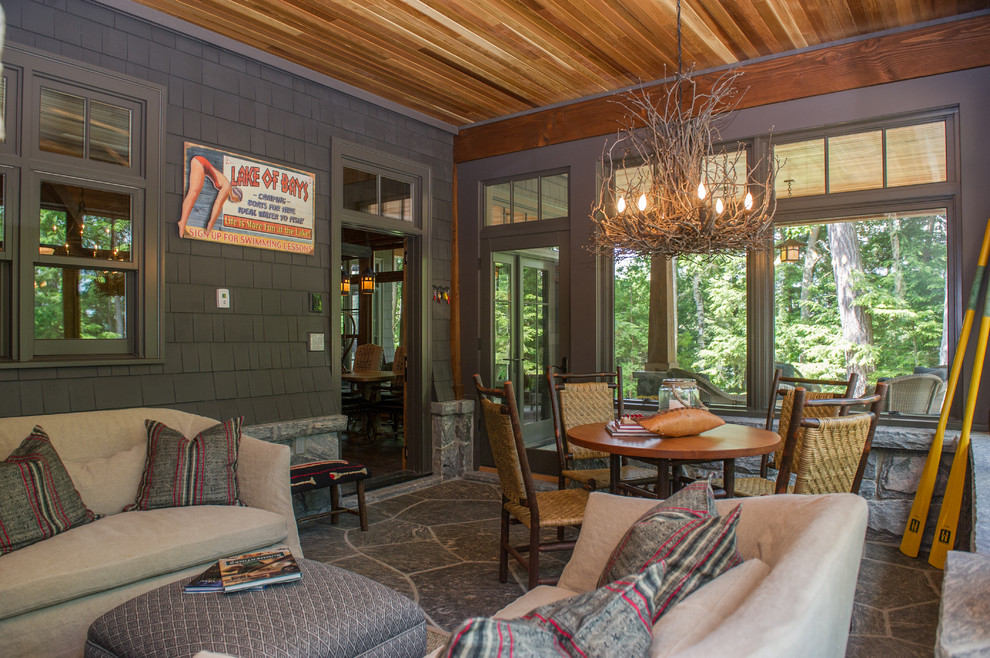 This is an example of a country sunroom in Toronto with a standard fireplace and a standard ceiling.