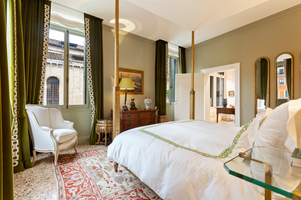 Photo of a mediterranean bedroom in Venice with green walls and brown floor.