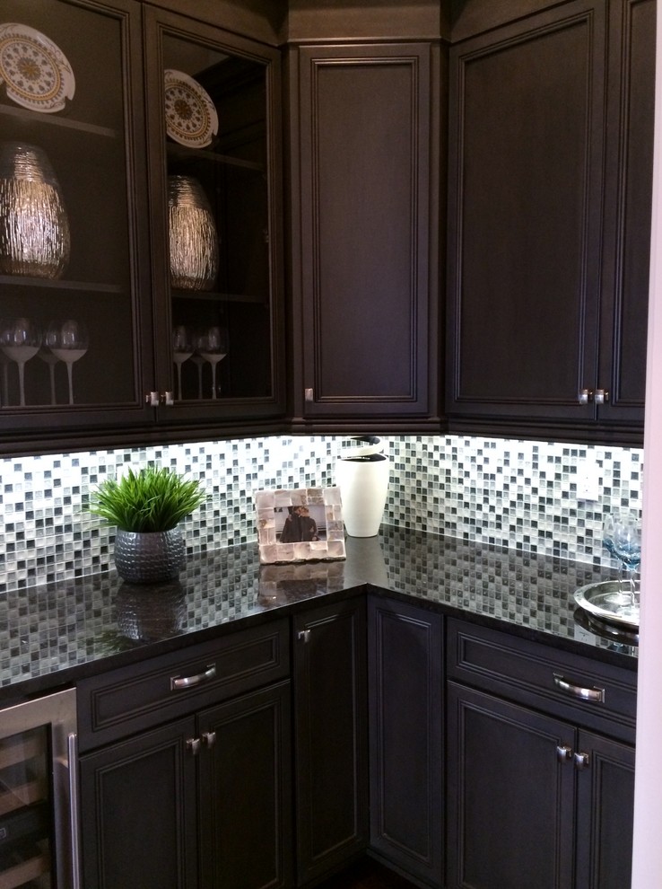 Mid-sized transitional l-shaped dark wood floor home design photo in Tampa with a drop-in sink, recessed-panel cabinets, dark wood cabinets, granite countertops, multicolored backsplash and glass tile backsplash