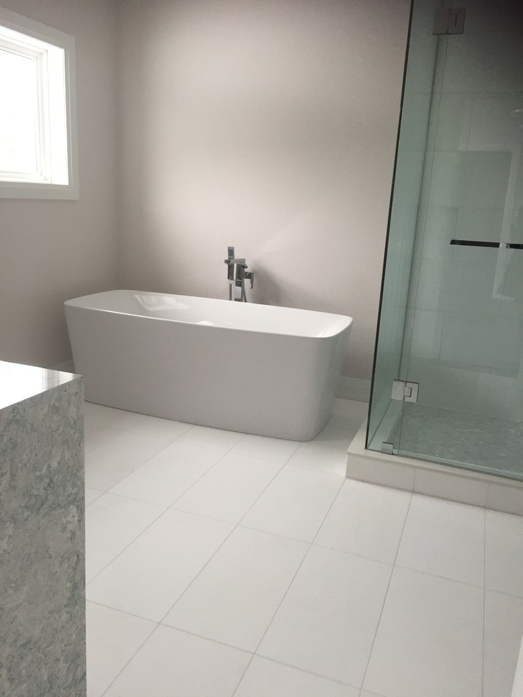 Large modern master bathroom in Toronto with a freestanding tub, beige walls, white tile, vinyl floors, a corner shower, white floor and a hinged shower door.