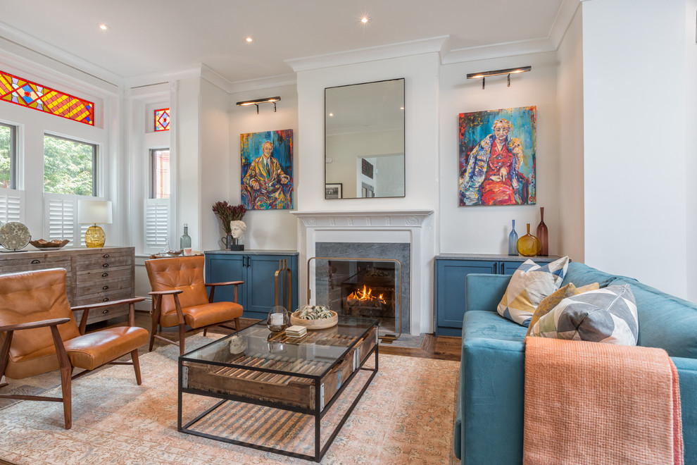 Eclectic formal living room in DC Metro with white walls, dark hardwood floors, a standard fireplace and no tv.