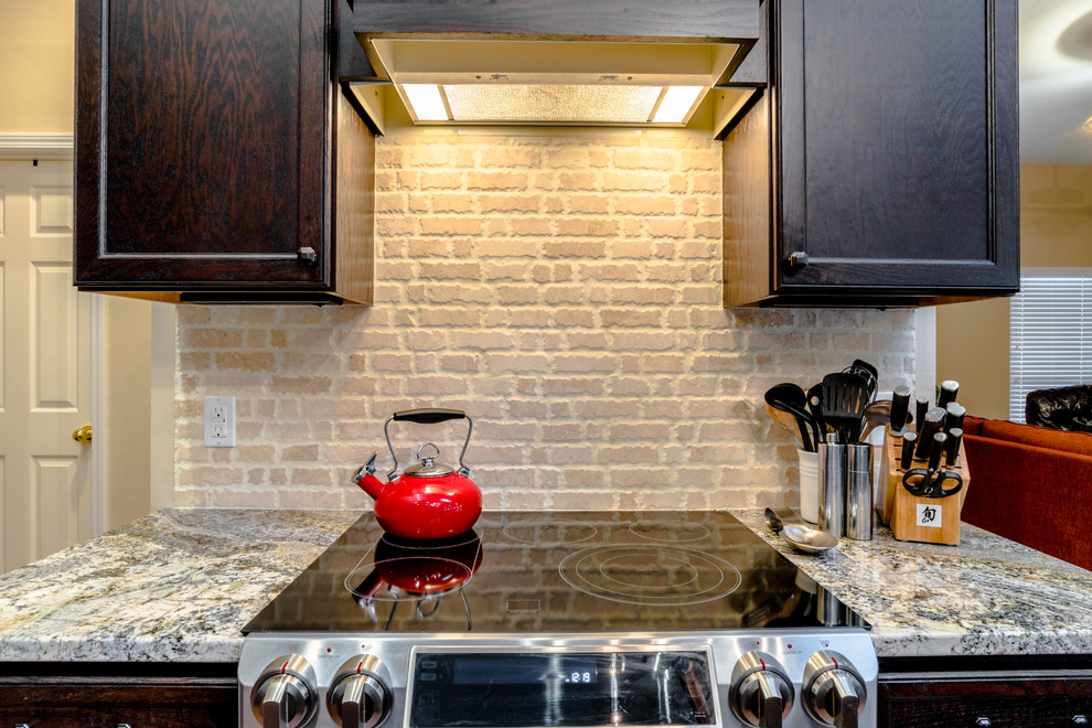 Inspiration for a large transitional l-shaped vinyl floor eat-in kitchen remodel in Miami with an undermount sink, shaker cabinets, dark wood cabinets, granite countertops, beige backsplash, porcelain backsplash, stainless steel appliances and an island