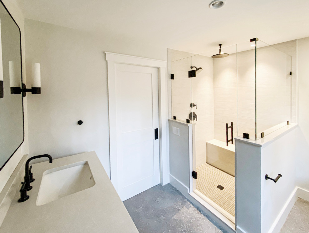 Photo of a large contemporary master bathroom in Boston with shaker cabinets, black cabinets, a corner shower, a two-piece toilet, white walls, cement tiles, an undermount sink, quartzite benchtops, grey floor, a hinged shower door and white benchtops.