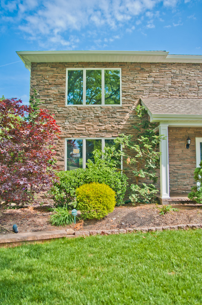 Inspiration for a large traditional two-storey brown exterior in New York with stone veneer.