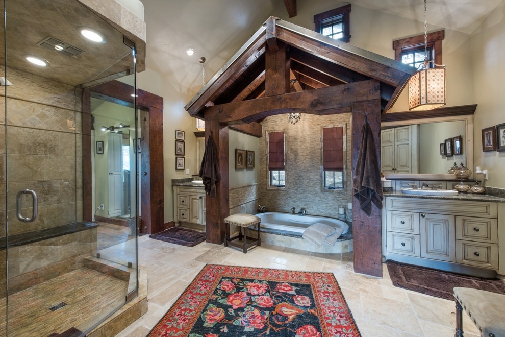 Inspiration for a country master bathroom in Salt Lake City with raised-panel cabinets, beige cabinets, a drop-in tub, a corner shower, beige tile, mosaic tile, beige walls, a drop-in sink and beige floor.