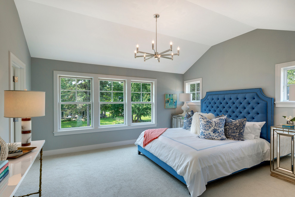 Photo of a large transitional master bedroom in Minneapolis with grey walls and carpet.