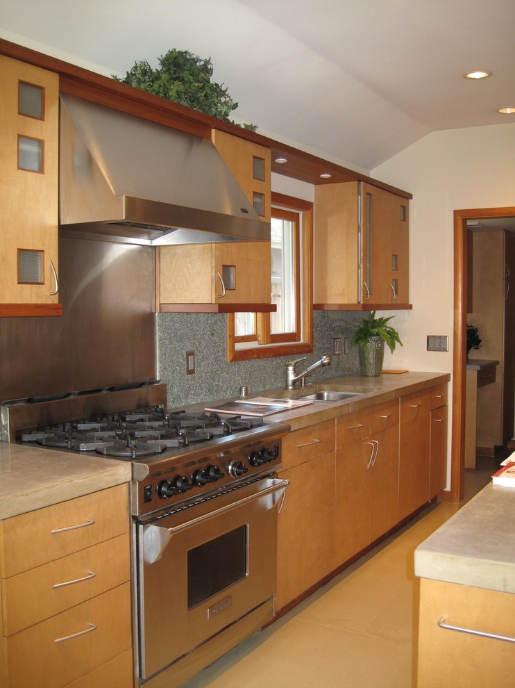 Mid-sized asian galley eat-in kitchen in San Francisco with a drop-in sink, flat-panel cabinets, light wood cabinets, concrete benchtops, grey splashback, cement tile splashback, stainless steel appliances, concrete floors and no island.