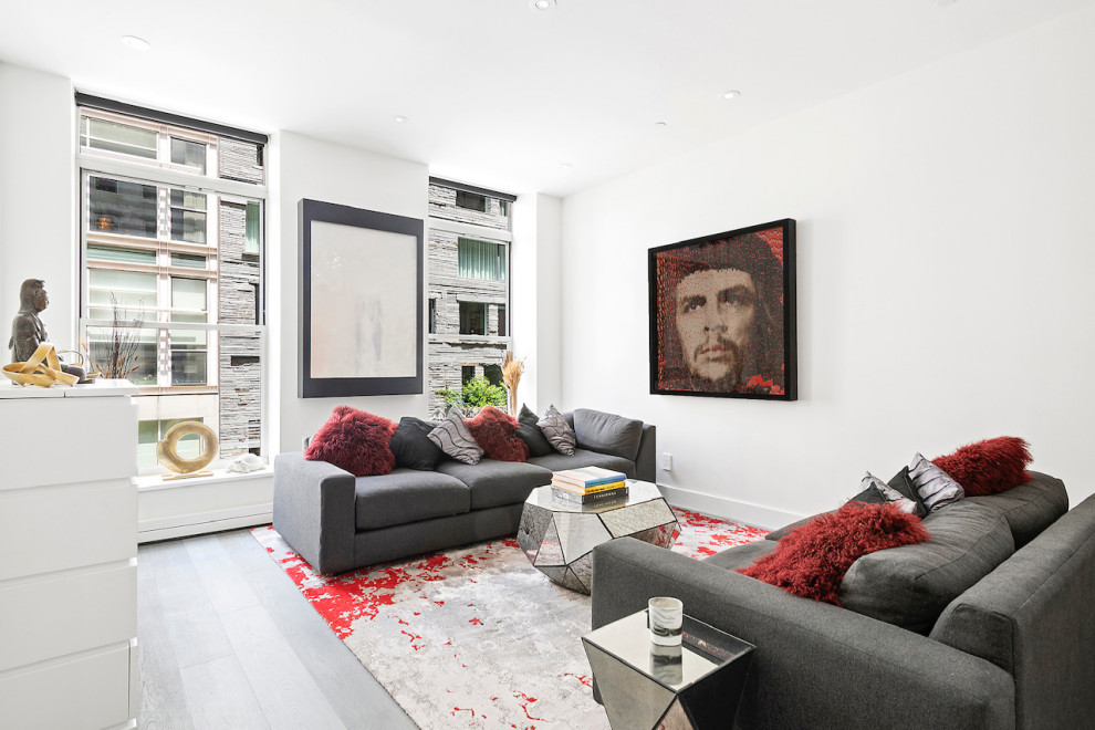 This is an example of a contemporary living room in New York with grey floor and white walls.