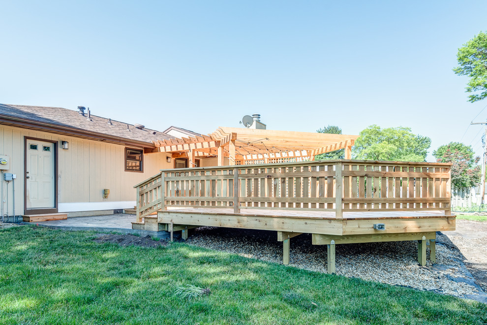 Deck - large transitional backyard deck idea in Chicago with a pergola