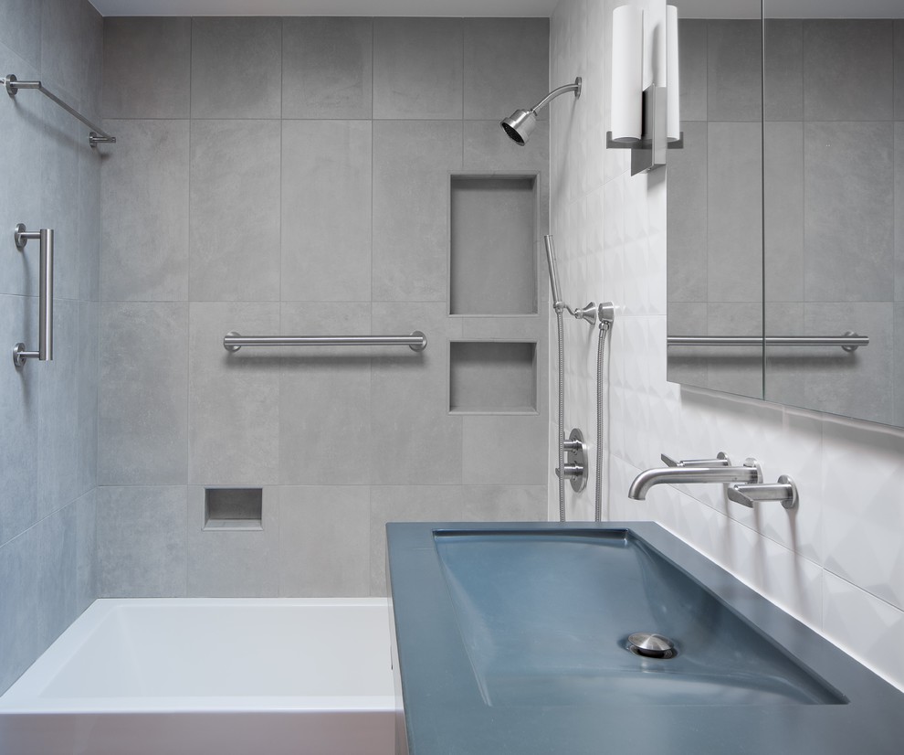 This is an example of a small midcentury 3/4 bathroom in Denver with flat-panel cabinets, brown cabinets, an alcove tub, an alcove shower, a one-piece toilet, white tile, porcelain tile, white walls, ceramic floors, a console sink, concrete benchtops, grey floor, a shower curtain and blue benchtops.