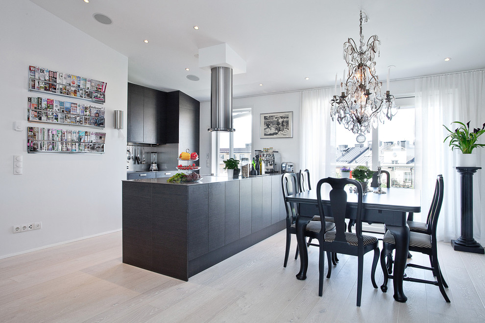 Mid-sized contemporary kitchen/dining combo in Stockholm with white walls, no fireplace and light hardwood floors.