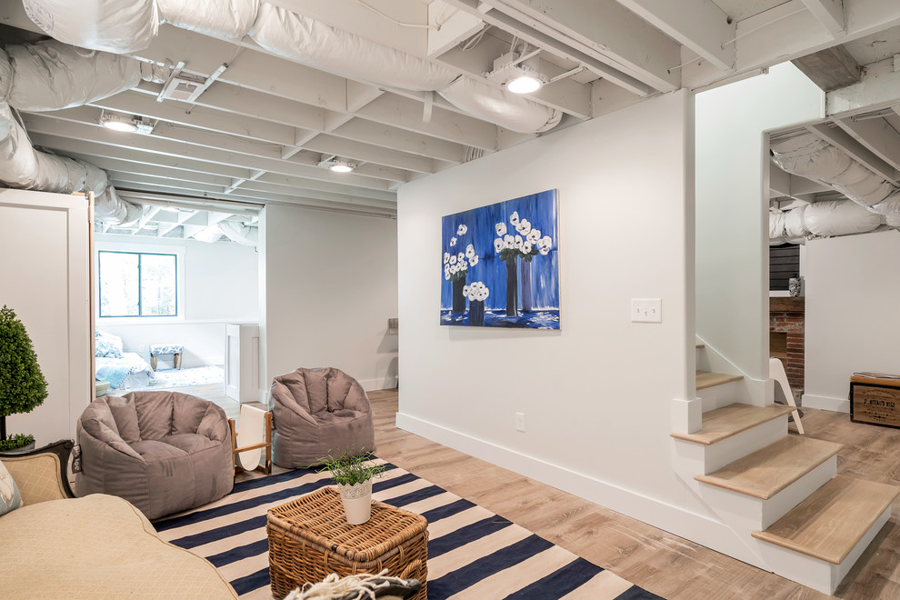 Basement - industrial light wood floor and beige floor basement idea in Atlanta with white walls