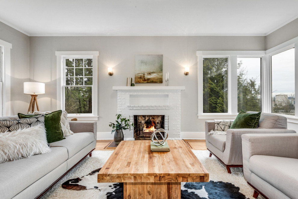 Medium sized traditional formal mezzanine living room in Seattle with grey walls, light hardwood flooring, a standard fireplace, a brick fireplace surround and grey floors.