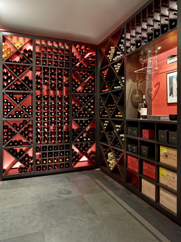 Photo of a small country wine cellar in London with slate floors and display racks.