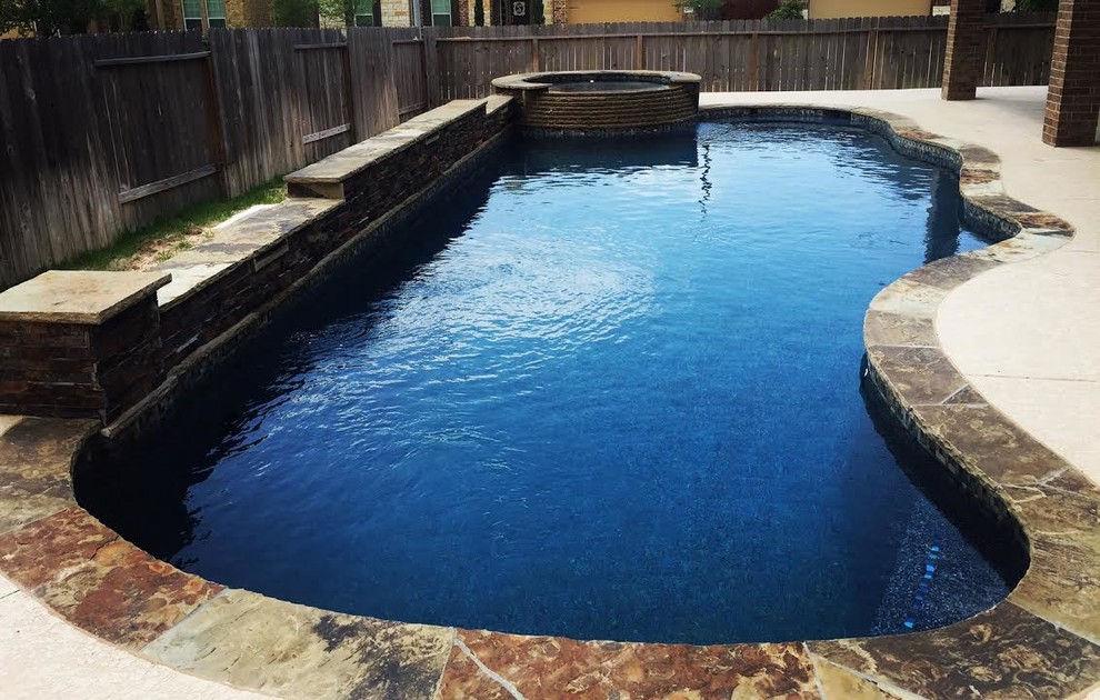 Example of a large transitional backyard stone and custom-shaped lap hot tub design in Houston