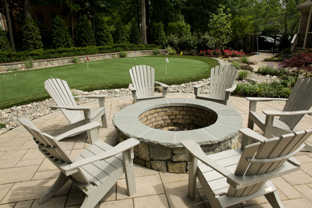 Inspiration for a mid-sized eclectic backyard patio in DC Metro with a fire feature and concrete pavers.