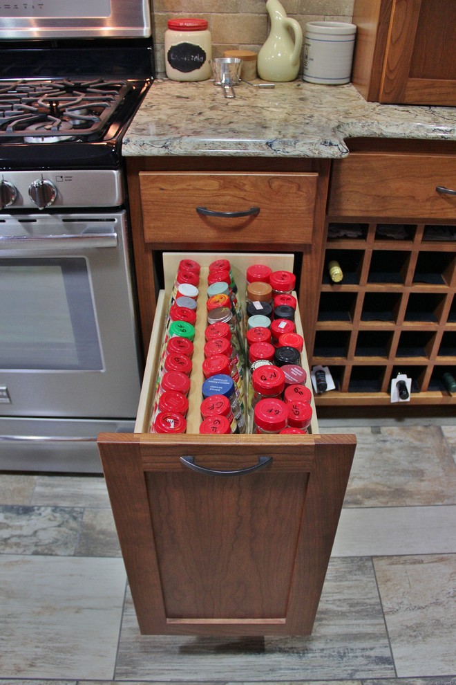 Inspiration for a mid-sized transitional galley ceramic tile enclosed kitchen remodel with an undermount sink, shaker cabinets, medium tone wood cabinets, quartz countertops, beige backsplash, stone tile backsplash, stainless steel appliances and a peninsula