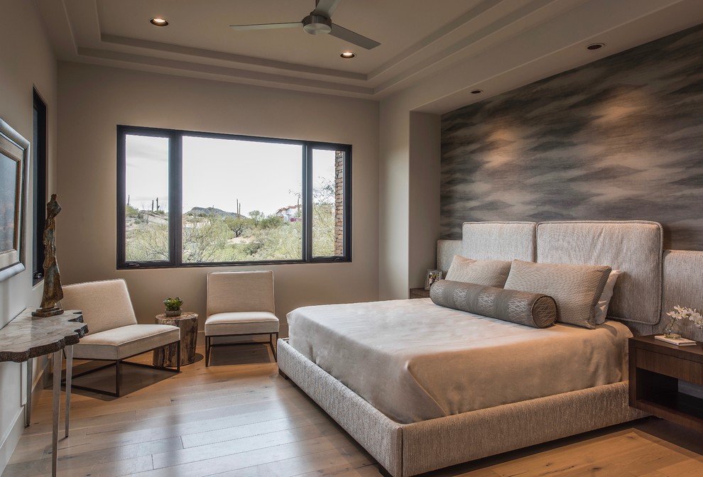 Design ideas for a large contemporary master bedroom in Phoenix with beige walls, medium hardwood floors, a ribbon fireplace and a concrete fireplace surround.