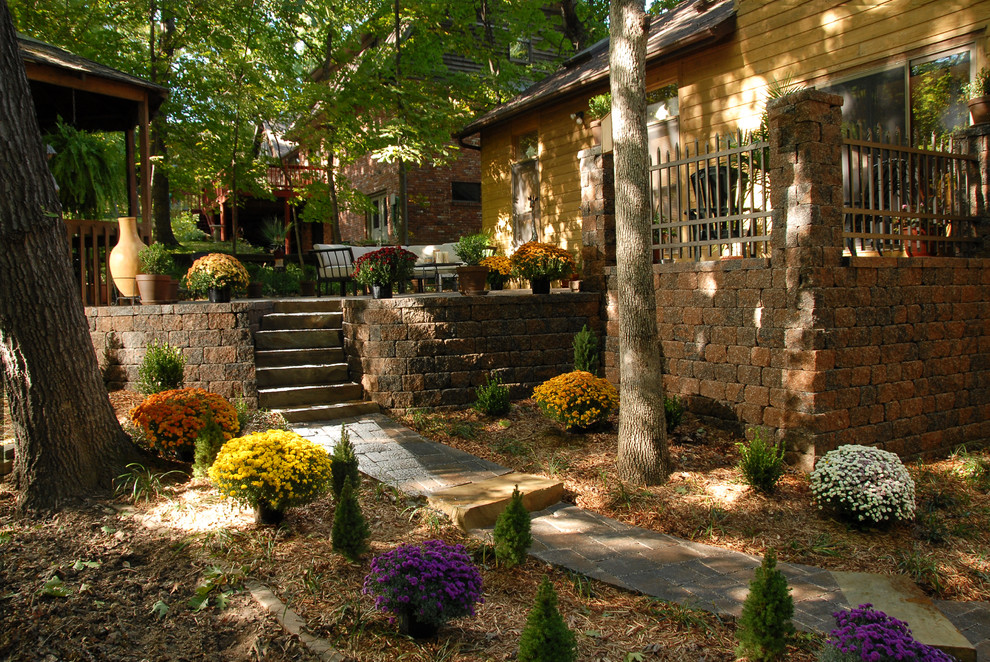 Design ideas for a rustic backyard concrete paver formal garden.