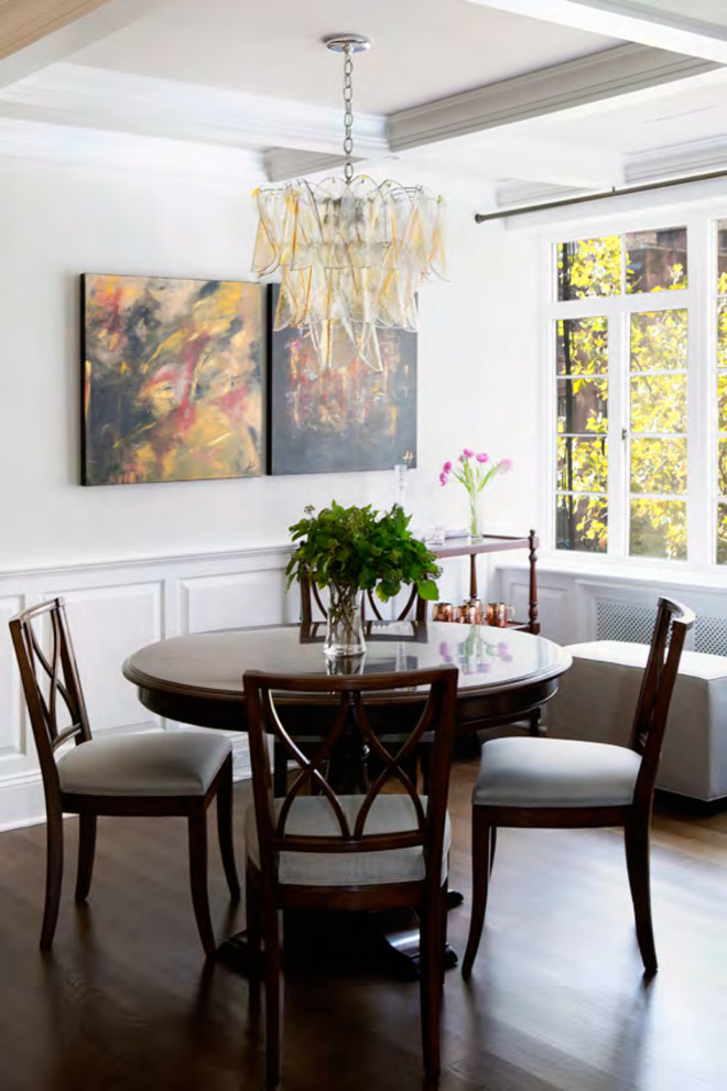 Photo of a transitional kitchen/dining combo in New York with white walls and dark hardwood floors.