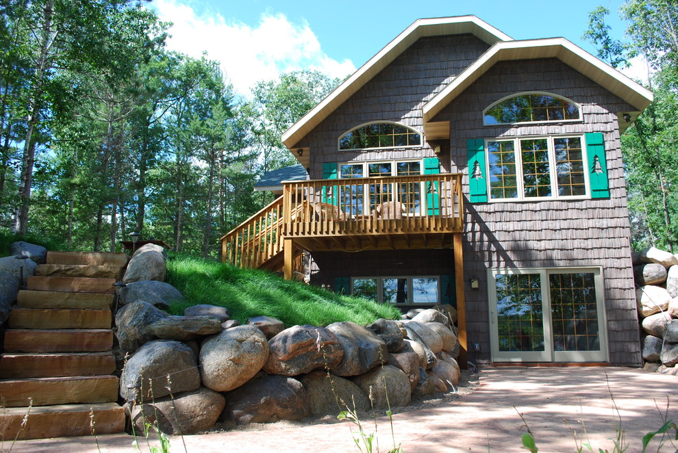 This is an example of a mid-sized transitional partial sun front yard concrete paver retaining wall landscape for summer.