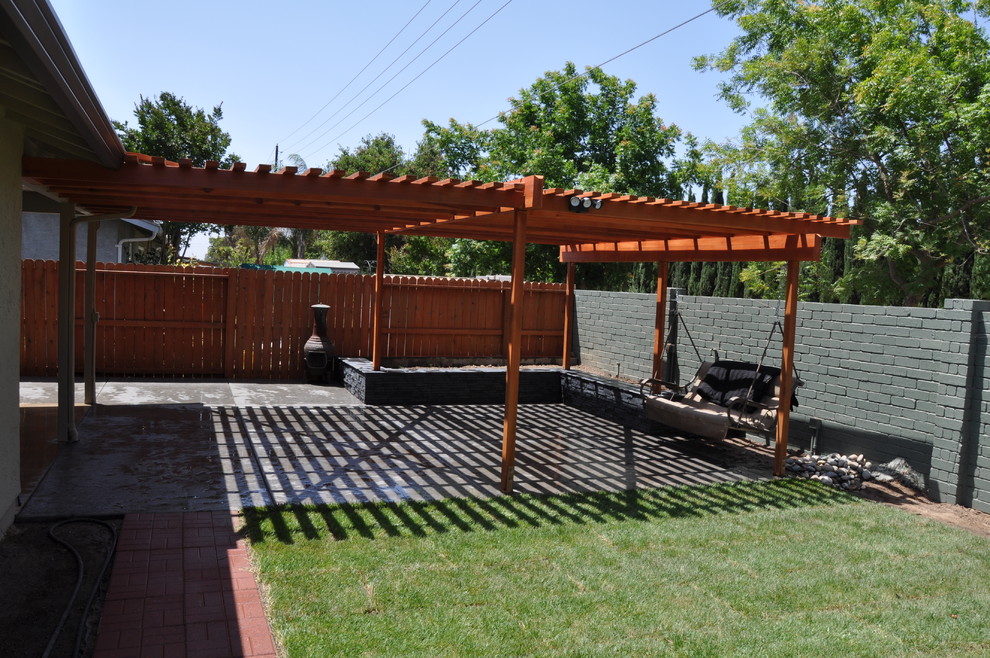 Photo of a mid-sized traditional backyard patio in Sacramento with concrete pavers, a pergola and a fire feature.