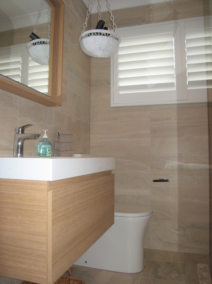 This is an example of a mid-sized contemporary master bathroom in Sydney with furniture-like cabinets, light wood cabinets, an open shower, beige tile, porcelain tile, beige walls, porcelain floors and beige floor.
