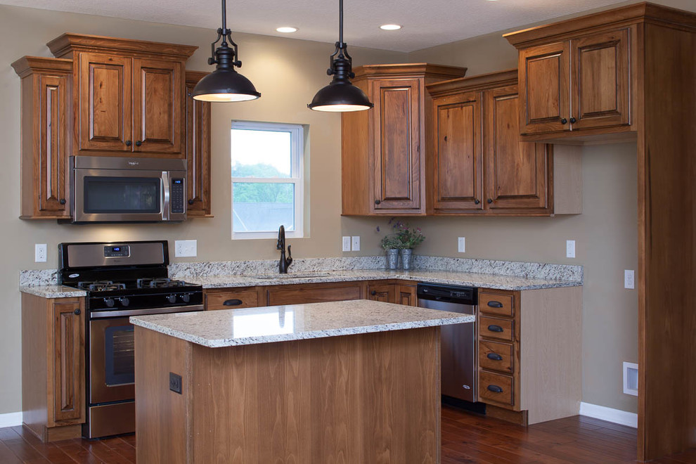 Inspiration for a rustic dark wood floor eat-in kitchen remodel in Chicago with a double-bowl sink, dark wood cabinets, granite countertops, stainless steel appliances and an island