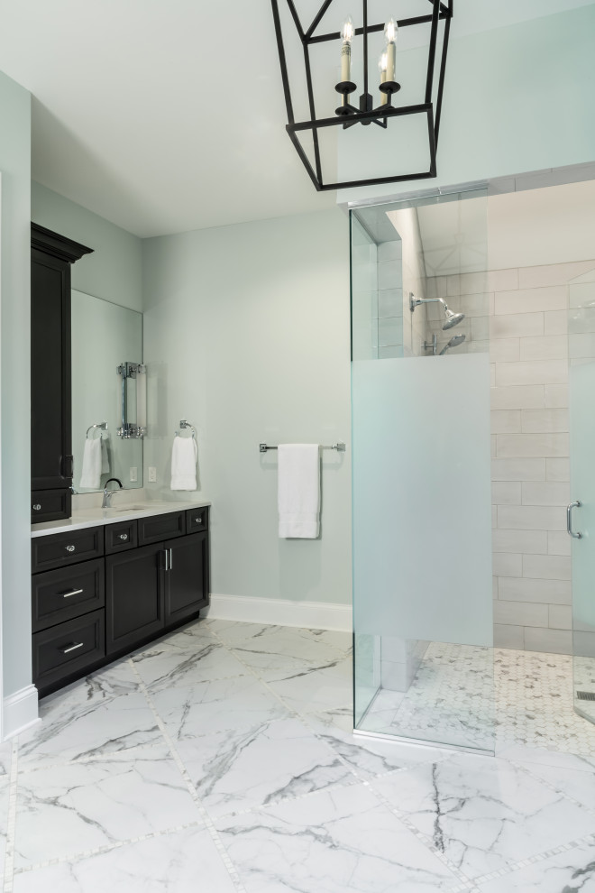 Inspiration for a large master bathroom in St Louis with recessed-panel cabinets, black cabinets, a curbless shower, gray tile, subway tile, blue walls, marble floors, an undermount sink, white floor, a hinged shower door, white benchtops, a single vanity and a built-in vanity.