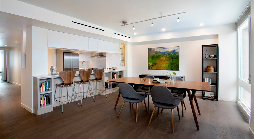 This is an example of a small contemporary kitchen/dining combo in Boston with white walls, dark hardwood floors and brown floor.