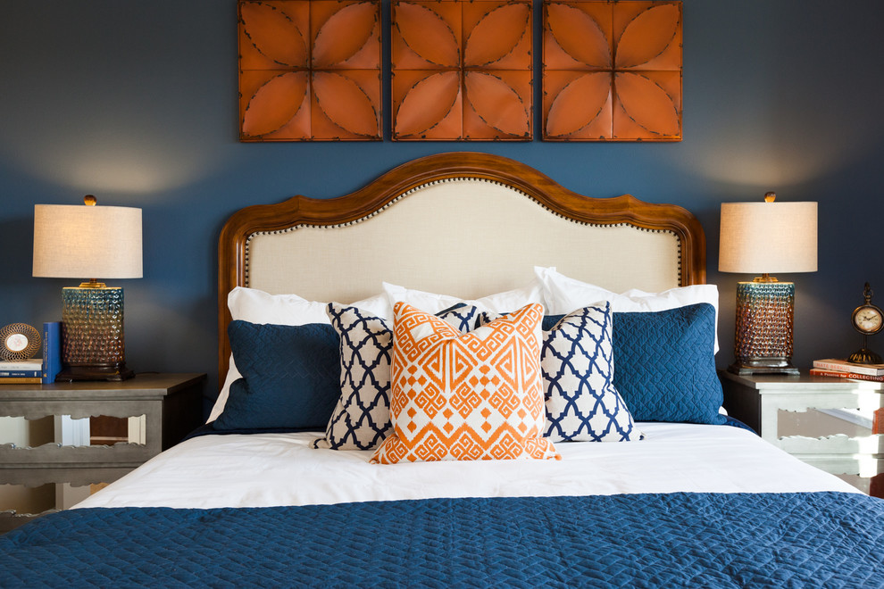 This is an example of a transitional bedroom in Houston with blue walls.