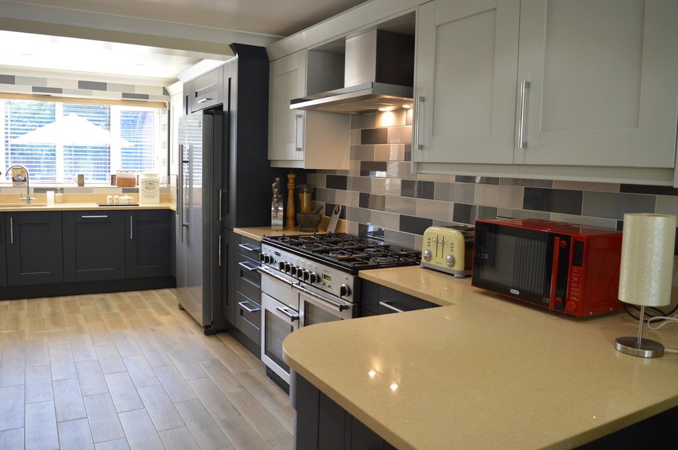 This is an example of a mid-sized contemporary u-shaped eat-in kitchen in Other with shaker cabinets, grey cabinets, quartzite benchtops, grey splashback, subway tile splashback, stainless steel appliances and no island.