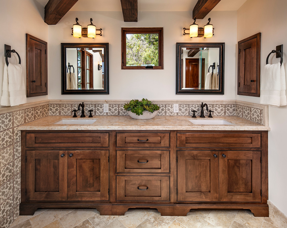 Design ideas for a large mediterranean master bathroom in Santa Barbara with an undermount sink, recessed-panel cabinets, medium wood cabinets, a freestanding tub, an open shower, beige tile, ceramic tile and beige walls.
