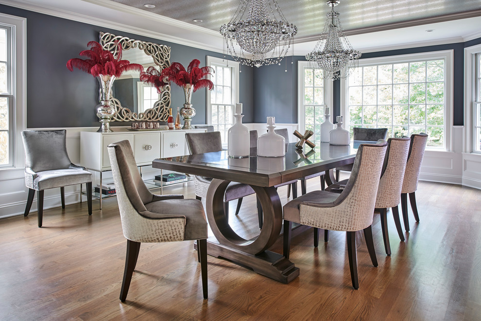 This is an example of a transitional separate dining room in New York with grey walls, medium hardwood floors and brown floor.