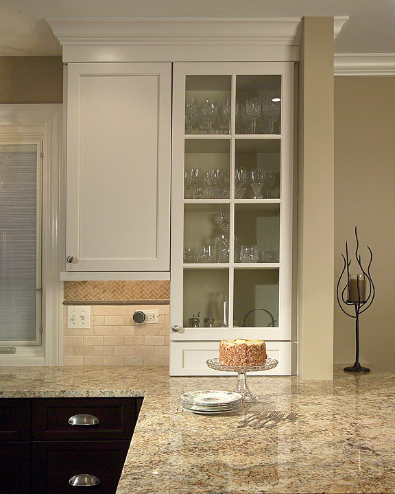 Inspiration for a transitional u-shaped eat-in kitchen remodel in Chicago with an undermount sink, flat-panel cabinets, granite countertops, beige backsplash, stone tile backsplash and stainless steel appliances