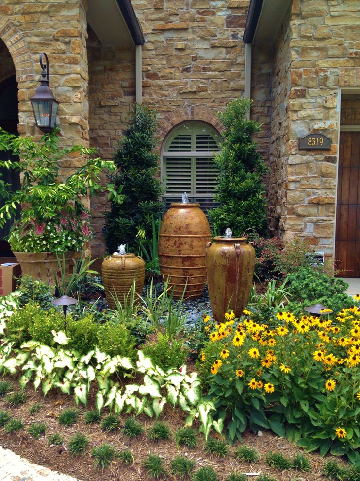 Inspiration for a large mediterranean front yard full sun formal garden for summer in Houston with a water feature.