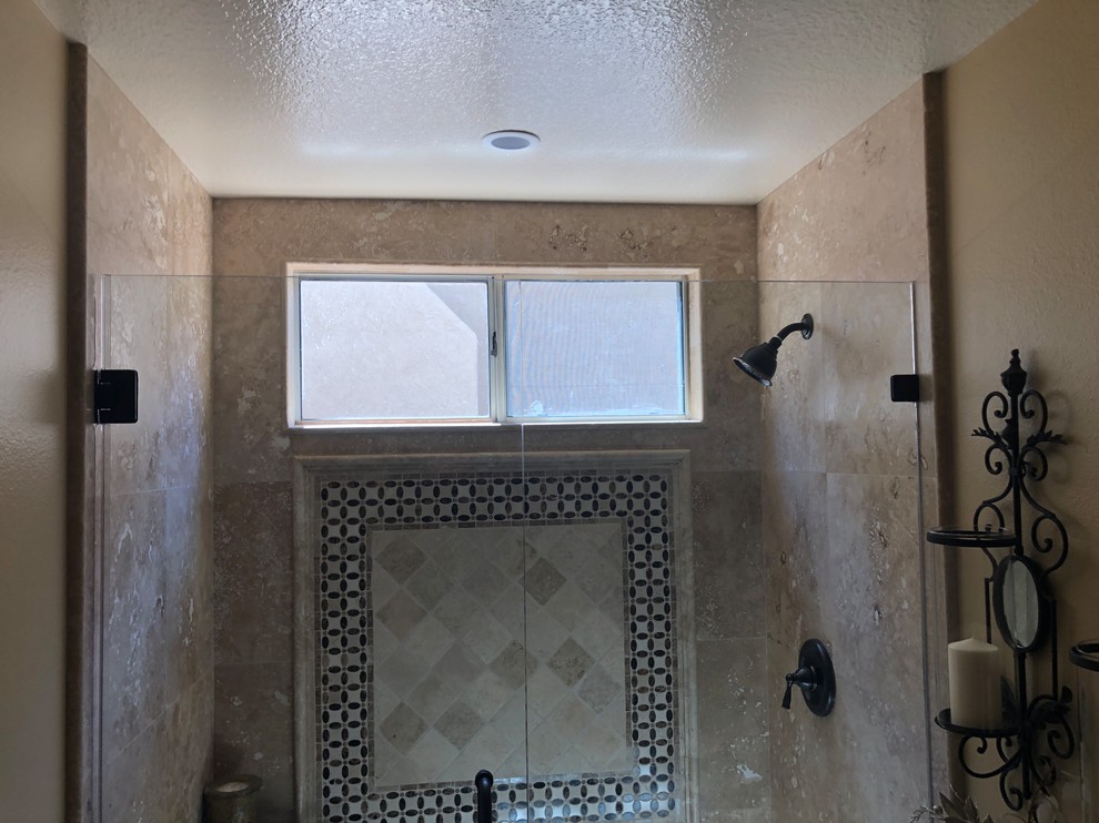 Photo of a traditional bathroom in Orange County with furniture-like cabinets, brown cabinets, an open shower, a two-piece toilet, beige tile, travertine, beige walls, dark hardwood floors, an undermount sink, granite benchtops, brown floor, a hinged shower door and beige benchtops.